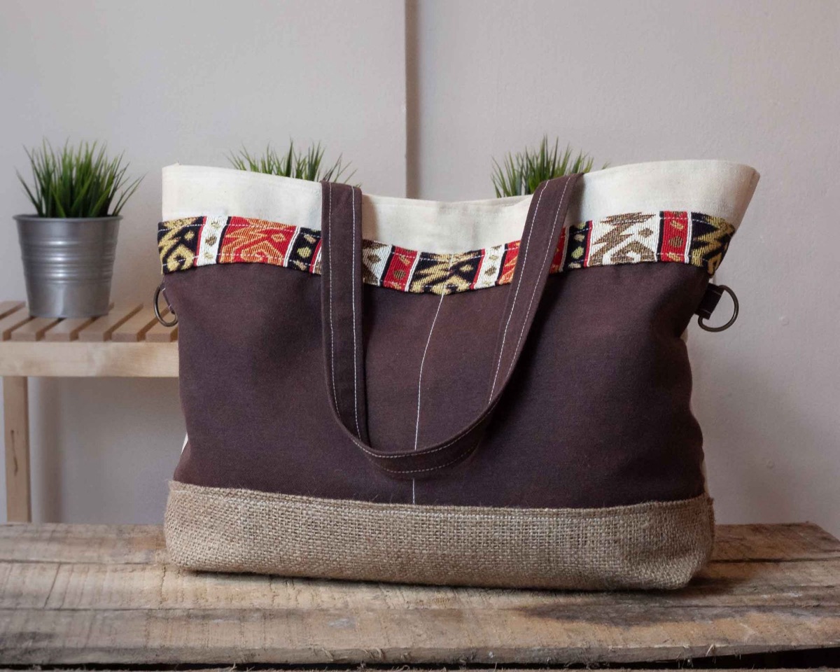 Tote bag with adjustable straps and padded interior for versatile carrying
